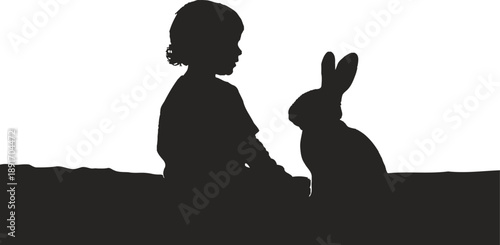 Silhouette of a child and a rabbit against a vibrant sunset background