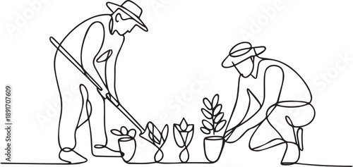 Two gardeners planting flowers and plants in the garden from a low viewpoint