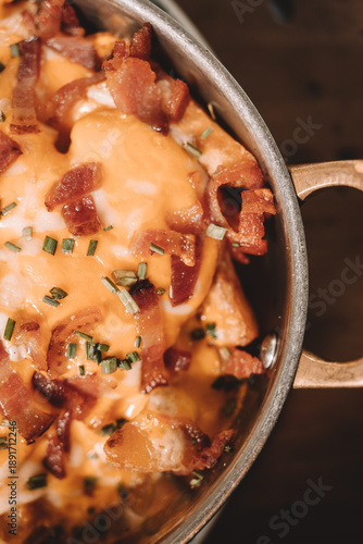 Cheesy bacon and egg dish served in rustic metal pan