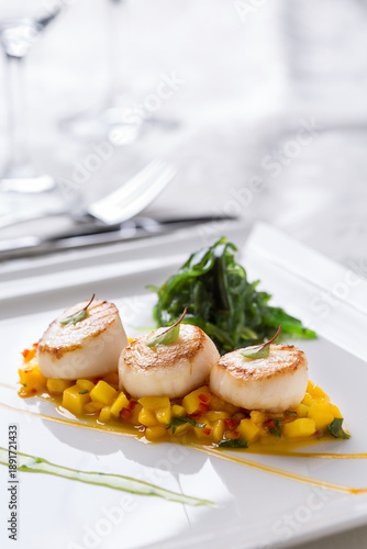 Seared scallops with mango salsa and seaweed salad