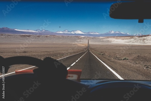 Obraz na plátně View from inside a vehicle driving along Ruta 23 across the Atacama Desert toward San Pedro de Atacama in northern Chile