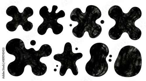 Abstract black inkblots resembling shapes and forms on a white background
