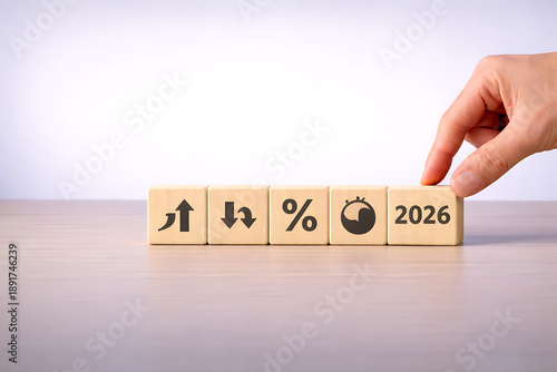 Wooden cubes with finance and economic icons representing forecast, growth, percentage, and future business target 2026