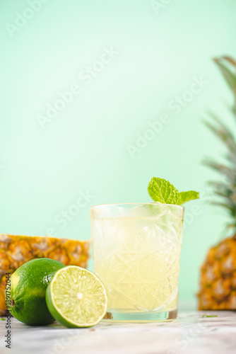 Refreshing Pineapple Lime Cocktail with Mint on Pastel Background