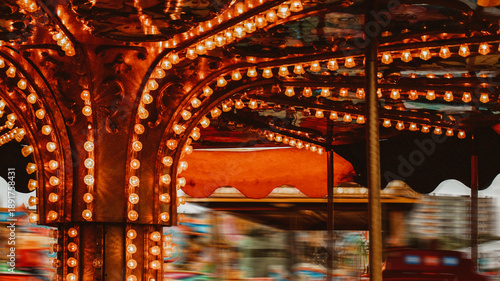 Spinning carousel with warm rustic lights bulb at fairground in Gniezno Poland