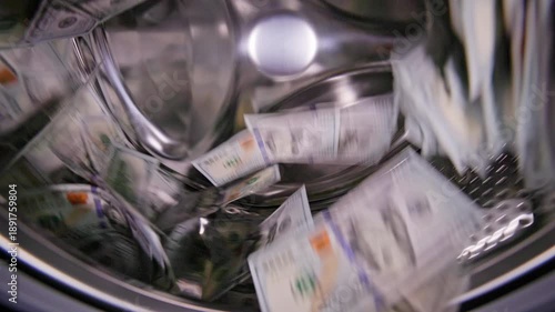 Hundred United States Dollar banknotes bouncing around inside washing machine for money laundering and fraud concept.