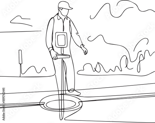 Man inspecting underground infrastructure with detection device at construction site