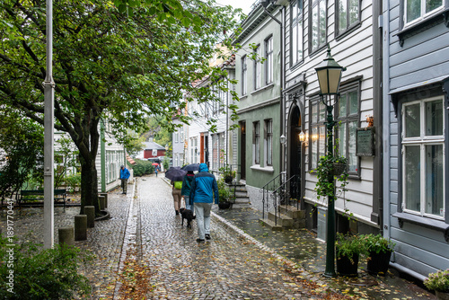 Wallpaper Mural Tourists walking during rainy weather at the Kroken street in the center of Bergen Torontodigital.ca