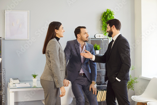 Fotografie Office people talk, colleagues wearing business attire, engaged in informal conv