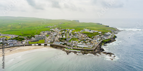 Tableau sur toile Aerial view of Kilkee, coastal town, popular as a seaside resort, located in horseshoe bay and protected from the Atlantic Ocean by the Duggerna Reef, county Clare, Ireland