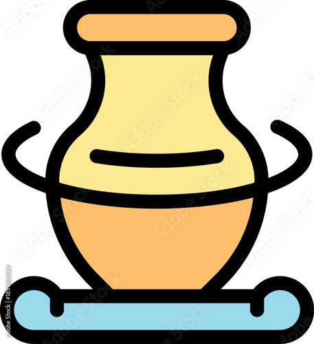 Clay vase rotating on pottery wheel during creation process in workshop