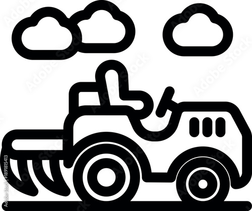 Small tractor plowing soil in agricultural field under cloudy sky, preparing land for cultivation and planting