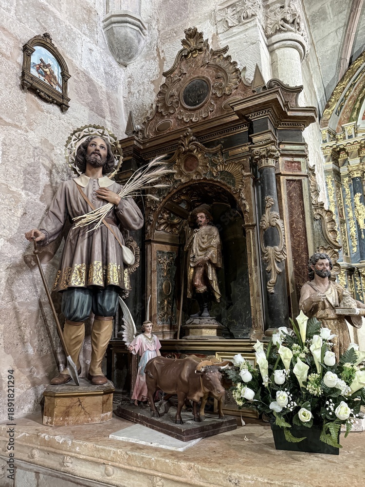 Obraz premium Statue of San Isidro Labrador with angel and oxen inside San Vicente Martir Church, Vega de Bur