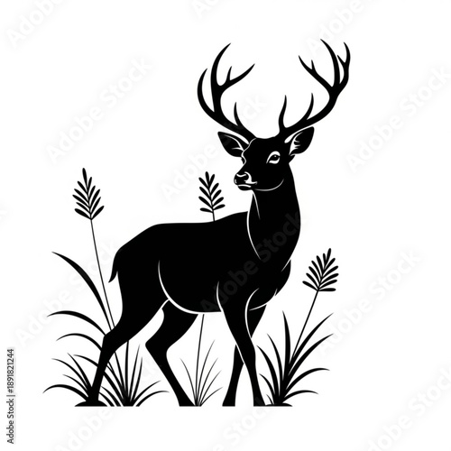 Black silhouette of a deer with antlers standing in grass