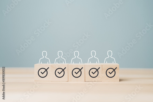 Minimal business concept show wooden blocks with check mark and people icon aligned in row, representing approved selection, verified candidate, quality control, recruitment success, team evaluation.