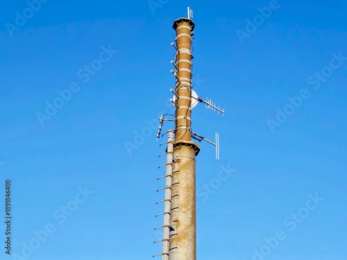 Elevated concrete skyscraper with numerous cellular units and safety features displayed prominently