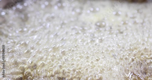 Melted sugar dissolved in water boiling, making syrup for oriental cakes like baklava