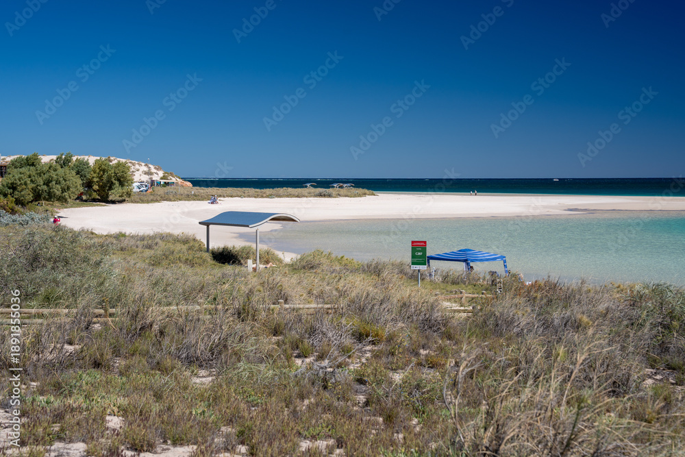 Fototapeta premium Stunning Coral Bay oceanfront white sandy beach turquoise waters pristine reef accessible from shore tropical Australian beach destination