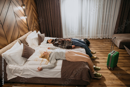 Fotografie Couple relaxing after long travel day in hotel