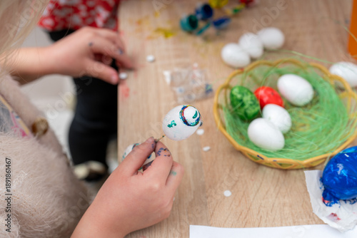 Children decorate Easter eggs during an arts and crafts activity in a community center on a spring afternoon