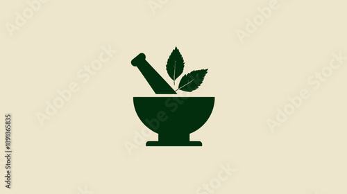 A dark green mortar and pestle with three leaves centered on a cream background