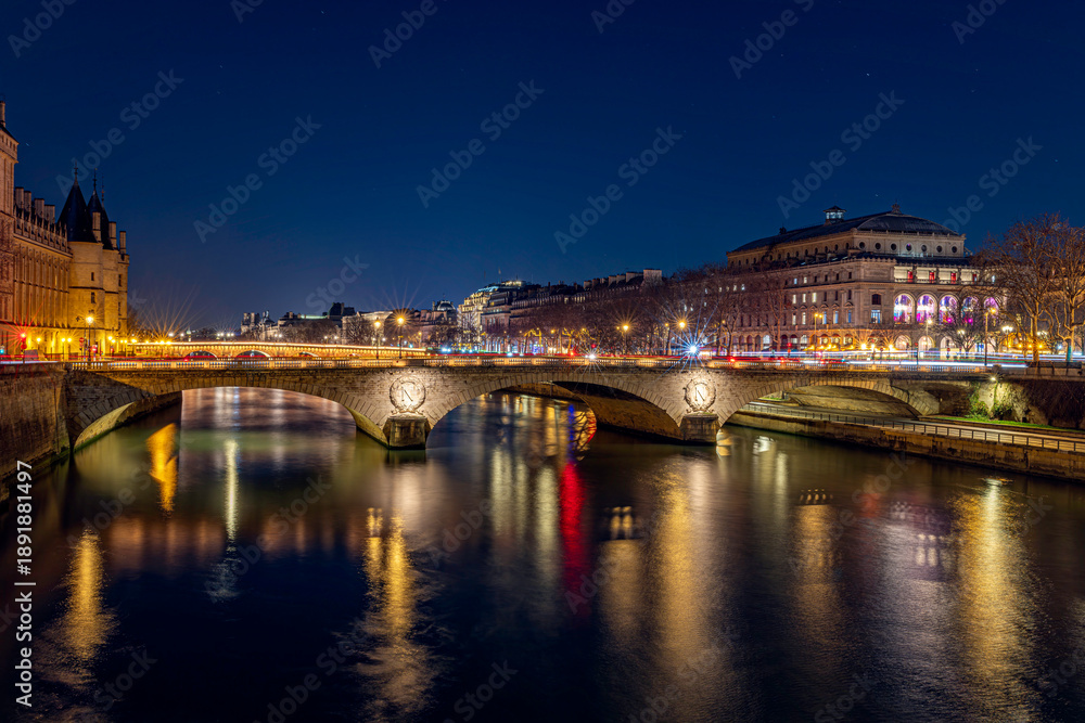 Obraz premium Night city bridge over river with illuminated buildings and reflections