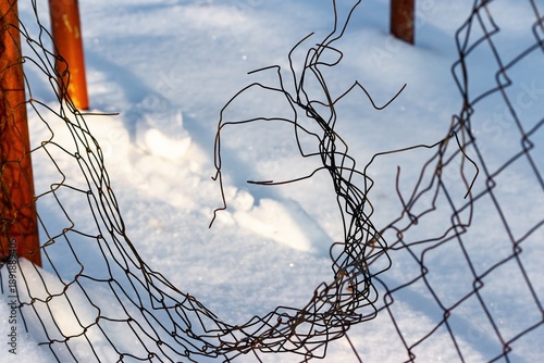 Wallpaper Mural Old, tattered wire fence on pristine white snow, bathed in warm evening sun. A symbol of decay and freedom against a serene winter backdrop Torontodigital.ca