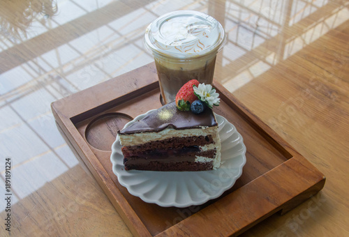 Coffee and chocolate cake with ice coffee in coffee shop.
