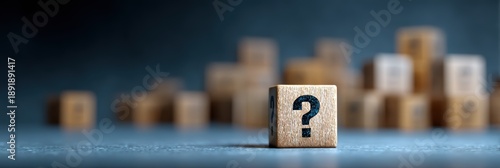 Black wooden cubes featuring question marks on a blue wooden surface