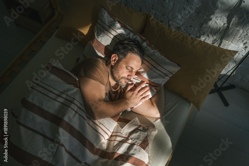 Foto Man sleeping peacefully in bed experiencing deep relaxation