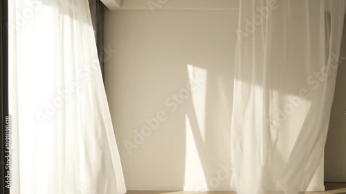 Bright room with sheer white curtains gently blowing in the breeze