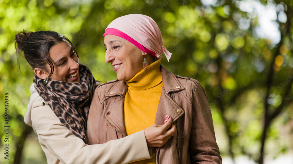 Fototapeta premium Mother and daughter celebrating cancer survival outdoors
