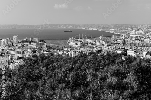 Panoramic aerial view od Marseille old port and its Mediterranean coastline; famous travel landmark city skyline of Marseille, Provence, France in black and white