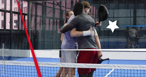 Tableau sur toile Embracing four racket players in sportswear sharing postmatch hug at net on blue
