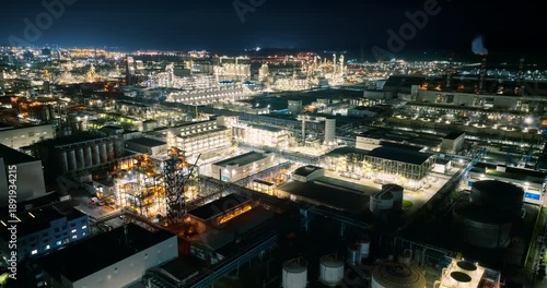 Wallpaper Mural Aerial shot of a massive industrial chemical plant illuminated at night with glowing lights. Torontodigital.ca