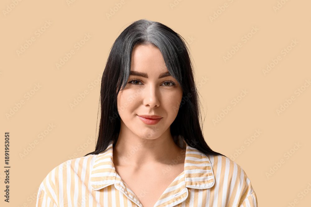 Obraz premium Young woman with graying hair on beige background