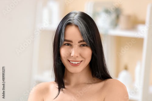 Young woman with graying ha...