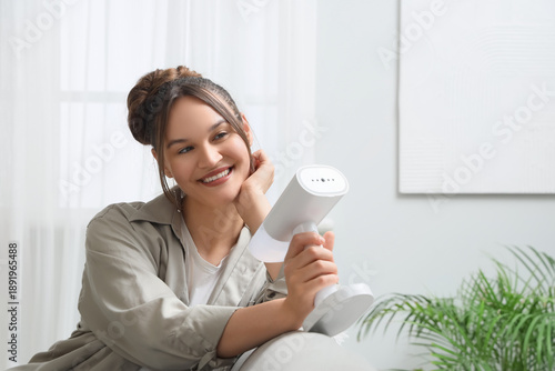 Beautiful young woman using...
