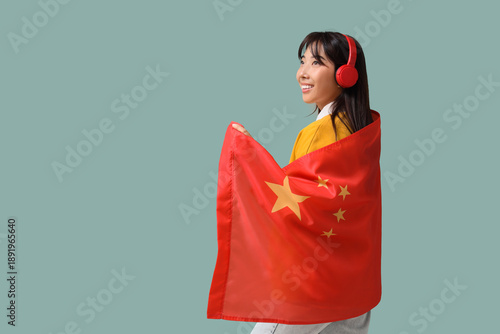 Young Asian woman in headph...