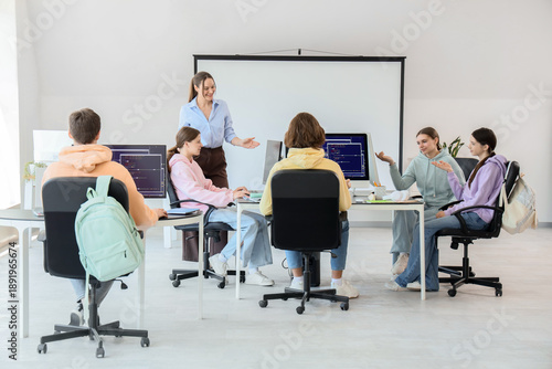 Teenage students with teach...