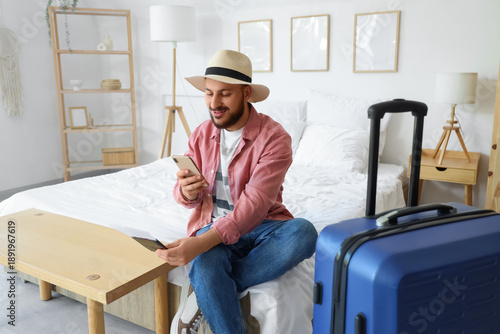 Male tourist with mobile ph...