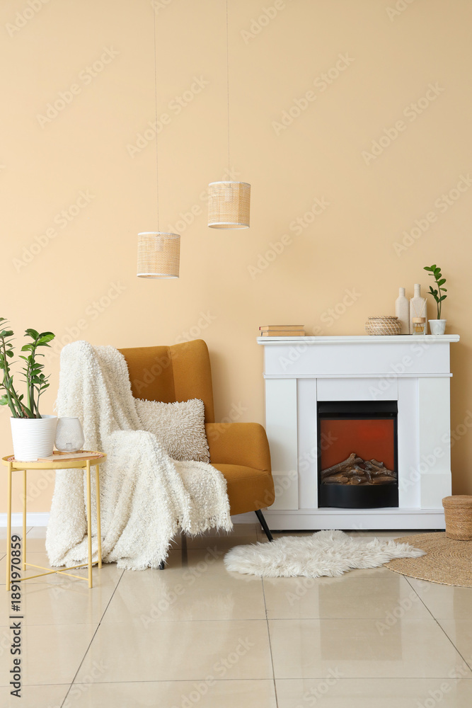Obraz premium Fireplace and armchair near beige wall in interior of room