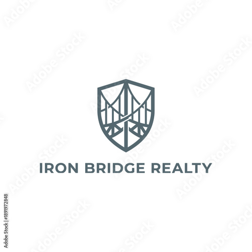 Professional bridge silhouette inside shield frame icon for real estate agency, property developer or broker brand named Iron Bridge Realty