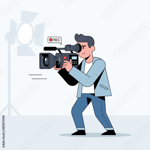 Filmmaker operating video camera in studio with spotlight