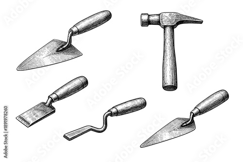 Set of vintage hand tools including hammer and trowels with wooden handles