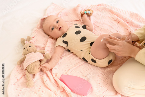 Mother with toys applying c...