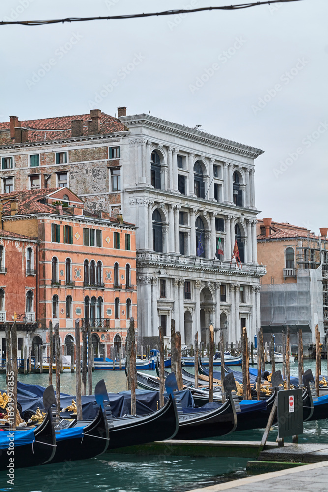 Fototapeta premium Moored gondolas on the Grand Canal with historic palazzo, Venice, Italy