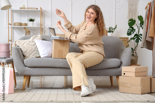 Young woman unpacking parce...