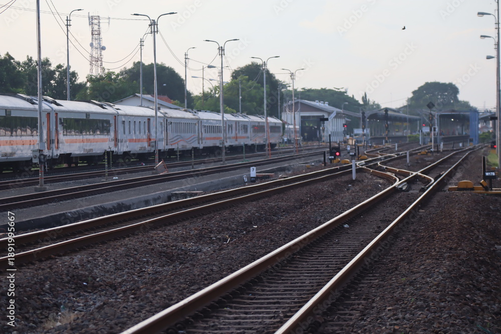 Fototapeta premium Train passing through multiple railway tracks at station area