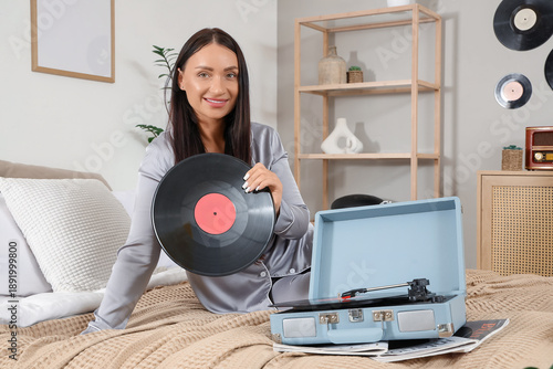 Young woman with vinyl disk...